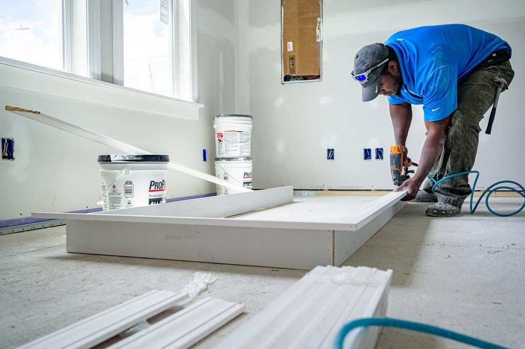 Maintenance technician working carefully inside a home
