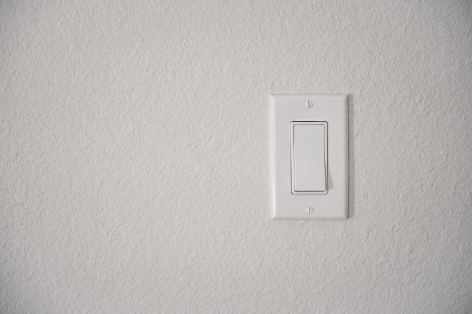 Illustrative after photo: neatly finished light switch
