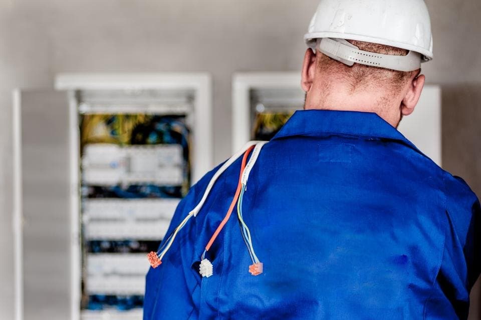 Electrician working on an open distribution board